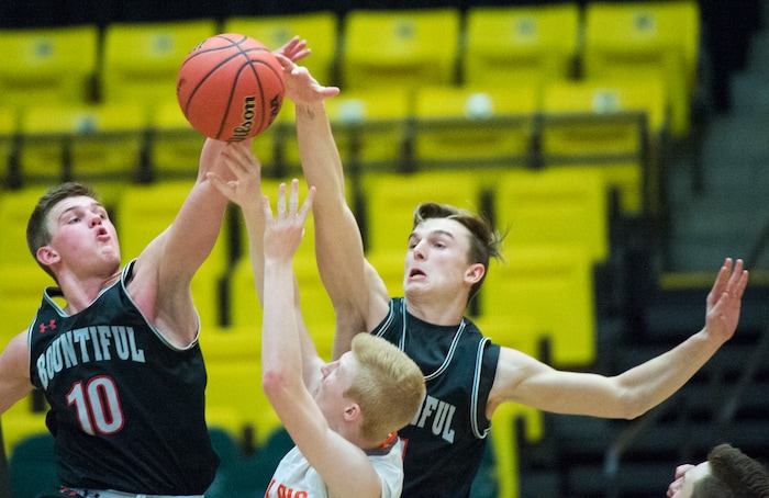 (Rick Egan  |  The Salt Lake Tribune)   Bountiful Braves Brig Willard (10) and  Braves Garrett Buchanan (11)  keep Skyridge Falcons Braden Allfrey (15) from getting a shot off in the final seconds of the game, in 5A basketball playoff action between the Bountiful Braves and Skyridge Falcons, at the UCCU Center in Orem, Monday, Feb. 26, 2018.