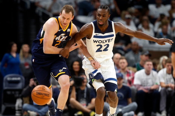 Utah Jazz's Joe Ingles, left, of Australia, and Minnesota Timberwolves' Andrew Wiggins chase a loose ball during the first half of an NBA basketball game Friday, Oct. 20, 2017, in Minneapolis. AP Photo/Jim Mone)