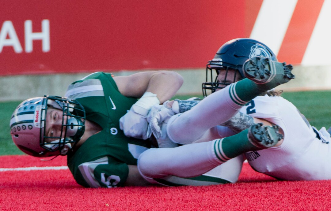 (Rick Egan  |  The Salt Lake Tribune)    Olympus receiver Noah Bennee hauls in a pass for a touchdown, as Corner Canyon defensive back, John Scheffner defends for the Chargers, in 5A football semifinal action between Olympus and Corner Canyon at Rice-Eccles Stadium, Thursday, Nov. 8, 2018.