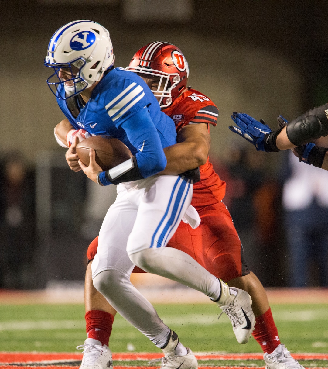 (Rick Egan  |  The Salt Lake Tribune)        Utah Utes defensive tackle Pita Tonga (49) wraps up Brigham Young Cougars quarterback Zach Wilson (11) for a sack,  in football action between the Brigham Young Cougars and the Utah Utes, at Rice-Eccles Stadium, Saturday, November 24, 2018.