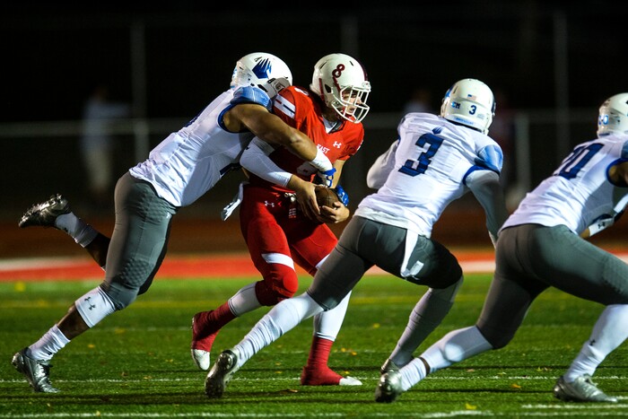 (Chris Detrick  |  The Salt Lake Tribune)  IMG Academy's Xavier Thomas (19) tackles East's Ben Ford (8) during the game at East High School Friday, October 20, 2017. 