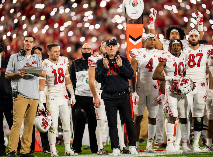(Rick Egan | The Salt Lake Tribune) Utah Utes head coach Kyle Whittingham and Utah football players salute Aaron Lowe and Ty Jordan during a break in the action, between Utah Utes and Ohio State Buckeyes in the Rose Bowl in Pasadena, Calif., on Saturday, Jan. 1, 2022.