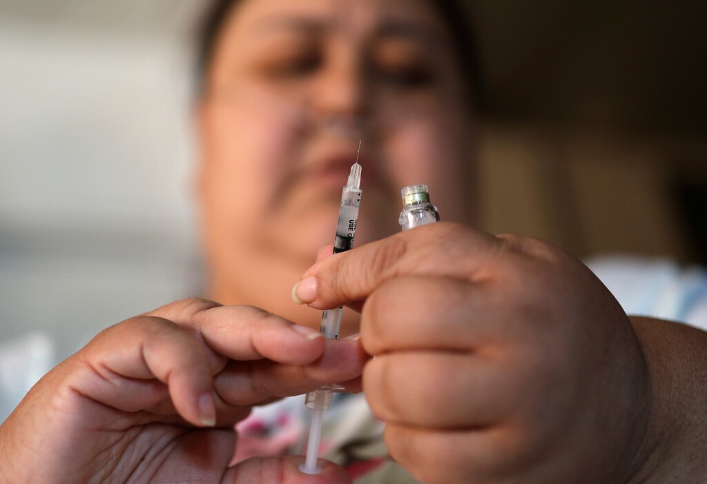(John Locher | The Associated Press) In this April 18, 2017, photo, Soila Solano prepares to inject herself with insulin at her home in Las Vegas. Solano was diagnosed with Type 2 diabetes six years ago. Casino owners and their employees’ unions are attempting to rein in soaring prescription drug prices in an attempt to control their own medical insurance costs. They and Democratic lawmakers backing the bill also hope it would cap what diabetics pay out of their own pockets for insulin.