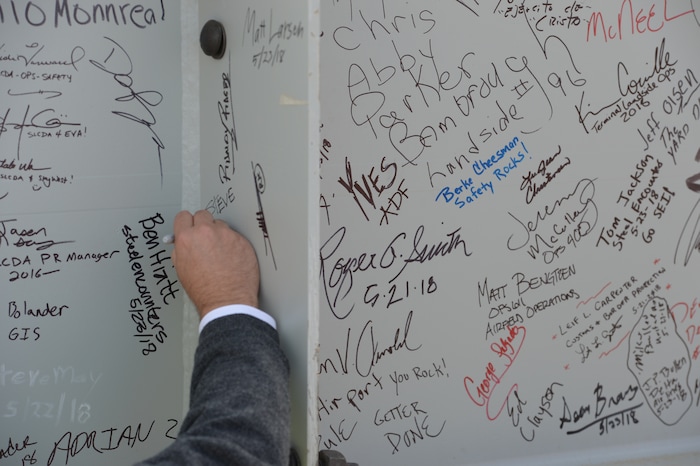 (Leah Hogsten  |  The Salt Lake Tribune) Attendees signed their name to the beam during Wednesday's "topping out" ceremony to raise the last steel beams to a high point on the new Salt Lake City International Airport terminal building, Wednesday, May 23, 2018. The new $485 million terminal building will cover 866,087 square feet and used 11,000 tons of structural steel and 22 miles of steel piles.