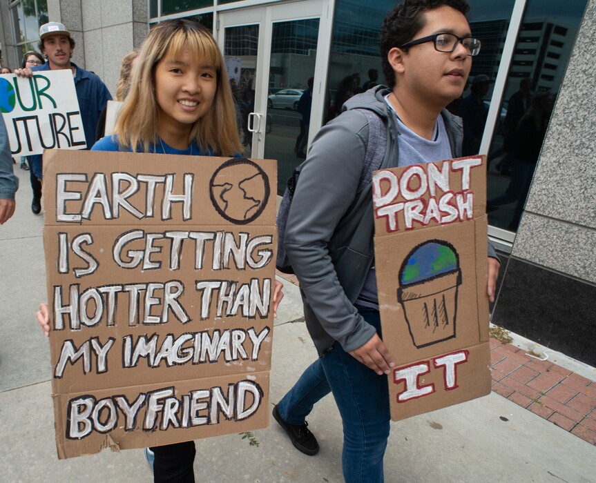 (Rick Egan  |  The Salt Lake Tribune)      Christa Truong and Pablo Ramirez march up to the Utah State Capitol Building, demanding action on the climate crisis. Friday, Sept. 20, 2019.