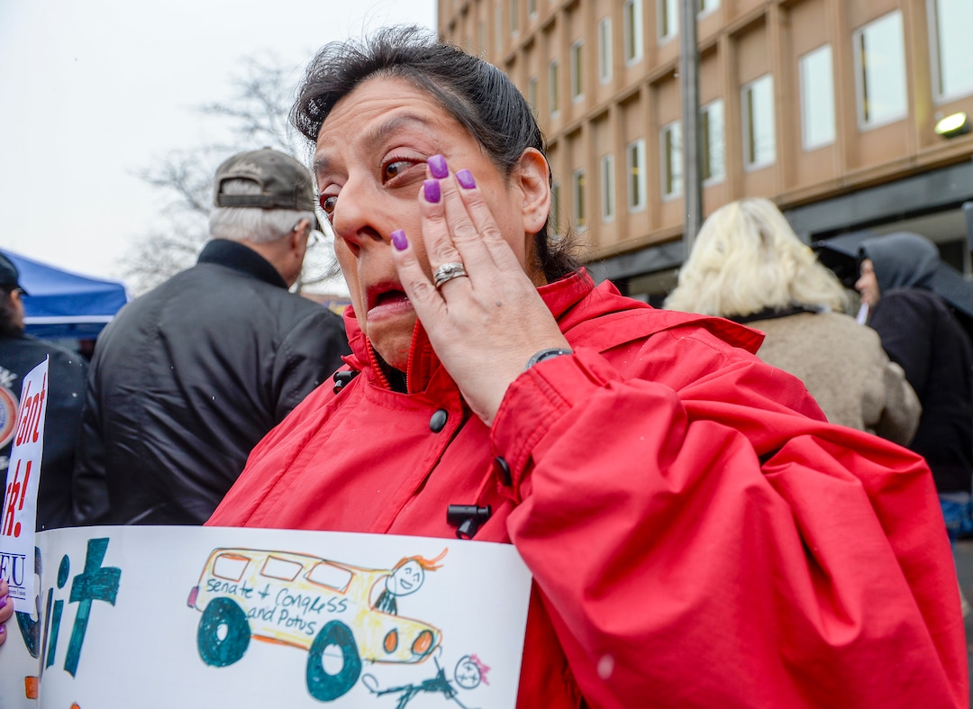 Leah Hogsten  |  The Salt Lake Tribune  Internal Revenue Service customer service representative Diane Zelazny wipes tears from her eyes from worry for her fellow IRS employees who don't have a spouse bringing in a second income and are under great stress and anxiety during a rally in protest of the ongoing partial federal shutdown outside Federal Building in Ogden, Jan. 10, 2019.