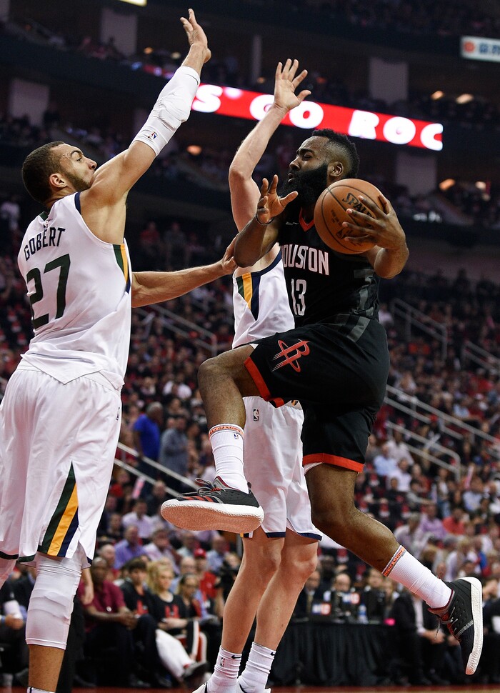 Houston Rockets guard James Harden, right, drives to the basket as Utah Jazz center Rudy Gobert (27) defends during the first half in Game 5 of an NBA basketball second-round playoff series, Tuesday, May 8, 2018, in Houston. (AP Photo/Eric Christian Smith)