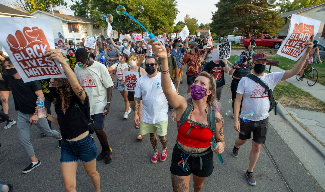 (Rick Egan  |  The Salt Lake Tribune)     Protesters dance through the neighborhood in Rose Park, during the Dance Dance for Revolution protest for racial equality, on Sunday, Aug. 23, 2020. The protest was in memory of Jovany Mercardo who was shot last August by Ogden police by four officers, hitting his body sixteen times.
