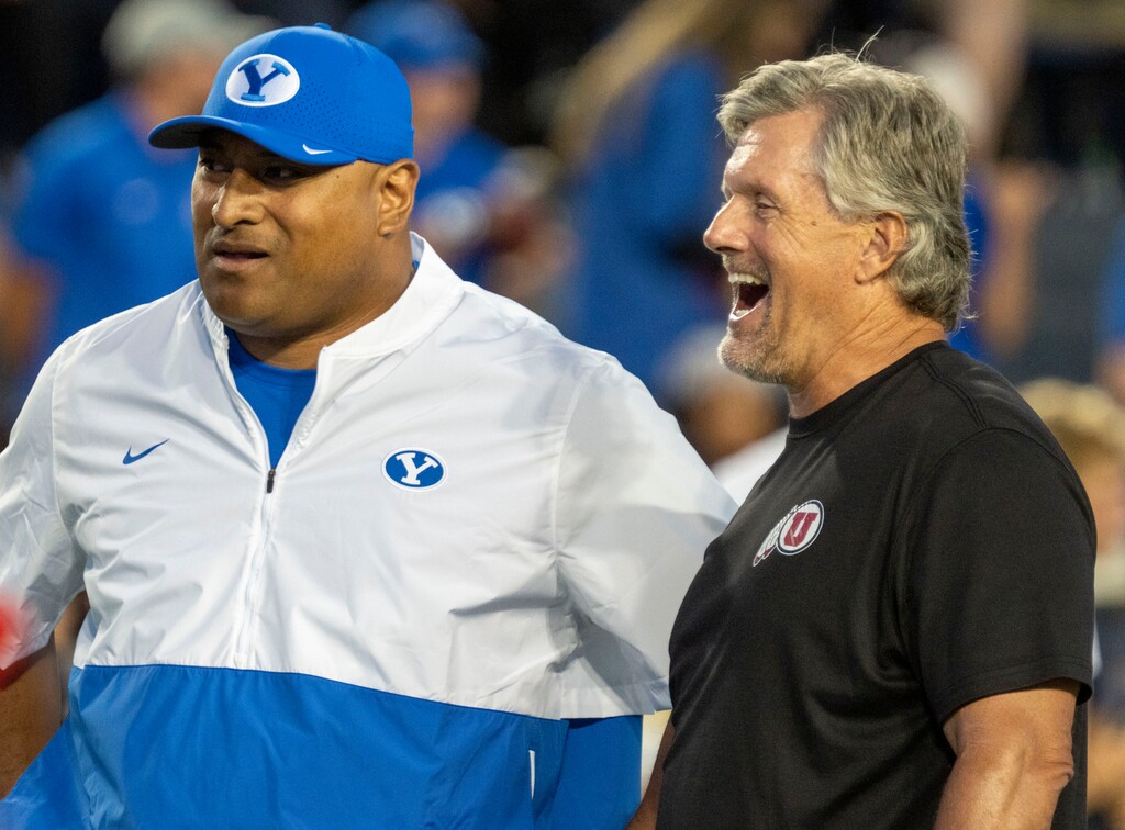 (Rick Egan | The Salt Lake Tribune) Brigham Young Cougars head coach Kalani Sitake visits with Utah Utes head coach Kyle Whittingham during warm-ups before football action between the Utah Utes and the Brigham Young Cougars at Lavell Edwards Stadium in Provo, on Saturday, Sept. 11, 2021.