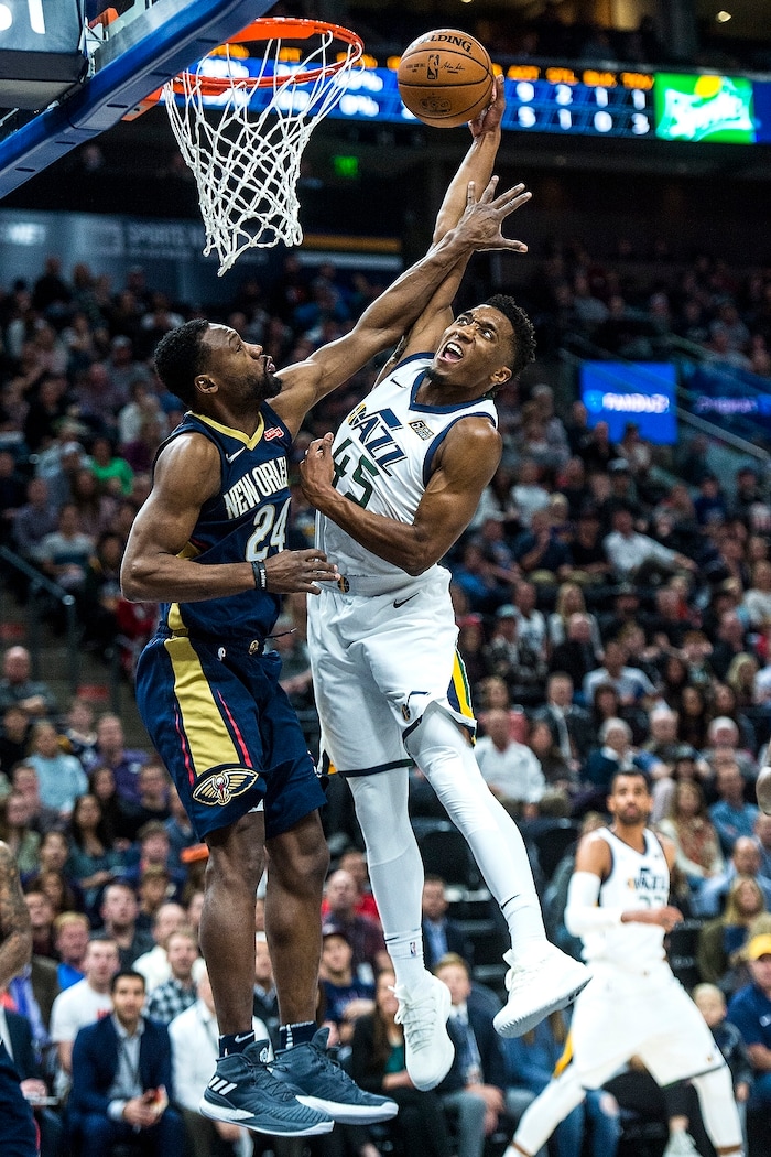 (Chris Detrick  |  The Salt Lake Tribune)  Utah Jazz guard Donovan Mitchell (45) is fouled by New Orleans Pelicans guard Tony Allen (24) as he attempts to dunk during the game at Vivint Smart Home Arena Friday, December 1, 2017.  