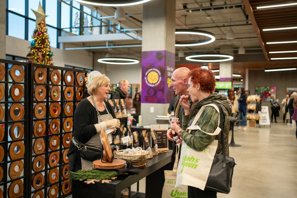 (Utah Department of Agriculture and Food) Vendors sell made-in-Utah products at the Utah's Own Holiday Shoppes at Millcreek Common in 2023. The shops will mark their second year, through Dec. 24, 2024, in the same location.