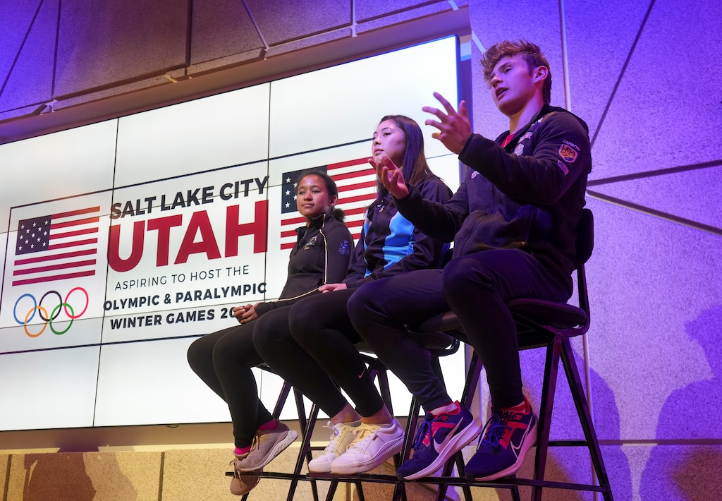 (Bethany Baker  |  The Salt Lake Tribune) Orson Colby, right, a young luge athlete from Riverton, speaks during a press event where the Salt Lake City-Utah Committee for the Games announced its delegation team at Kiln in Salt Lake City on Tuesday, July 9, 2024.
