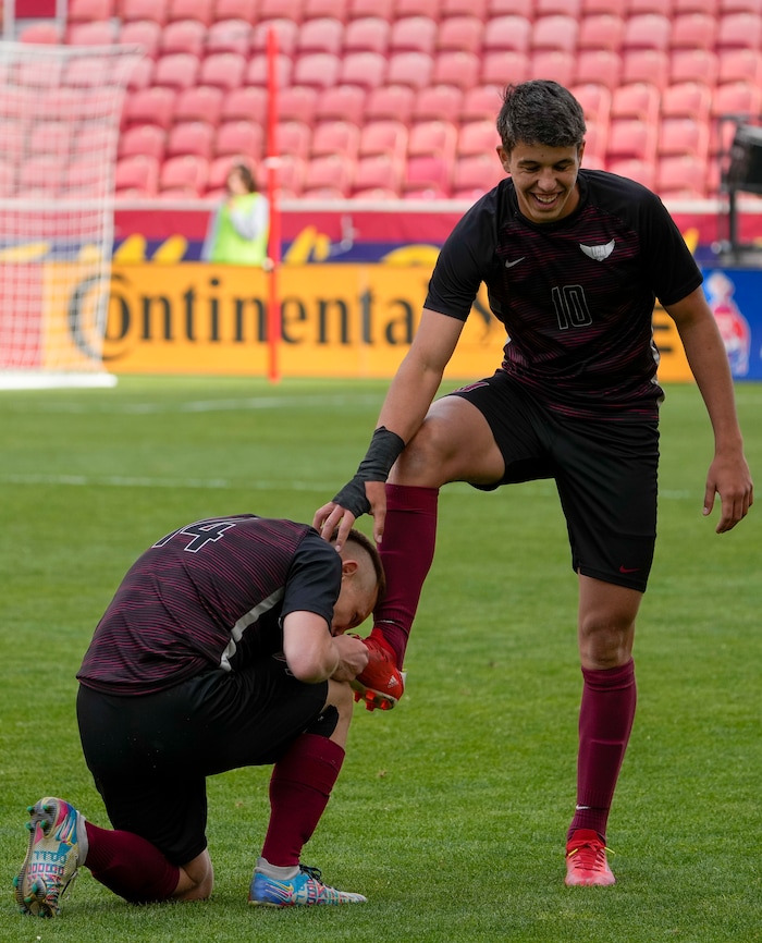 (Leah Hogsten | The Salt Lake Tribune) Layton Christian Academy's Roberto Neto shines and kisses the cleats of Enzo Jaques after Jaques' hat trick to win for the 3A State Soccer Championship title at Rio Tinto Stadium, Wednesday, May 11, 2022. Layton Christian Academy defeated Real Salt Lake Academy 4-0. 
