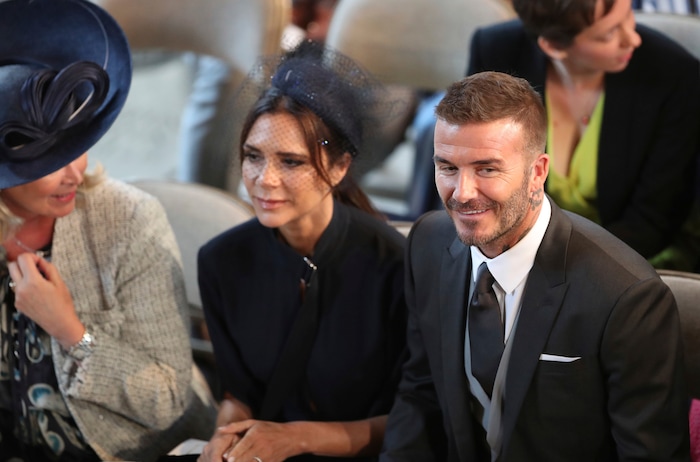 David and Victoria Beckham take their seats for the wedding of Prince Harry and Meghan Markle St. George's Chapel in Windsor Castle in Windsor, near London, England, Saturday, May 19, 2018. (Danny Lawson/pool photo via AP)