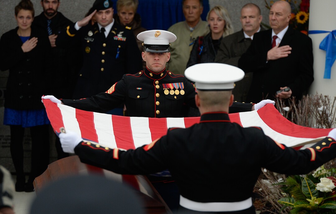 (Francisco Kjolseth  |  The Salt Lake Tribune)  Members of the Marine Corps fold the flag draping the casket of police officer David Romrell during funeral services at Larkin Sunset Gardens Cemetery in Sandy, Wed. Dec. 5, 2018.