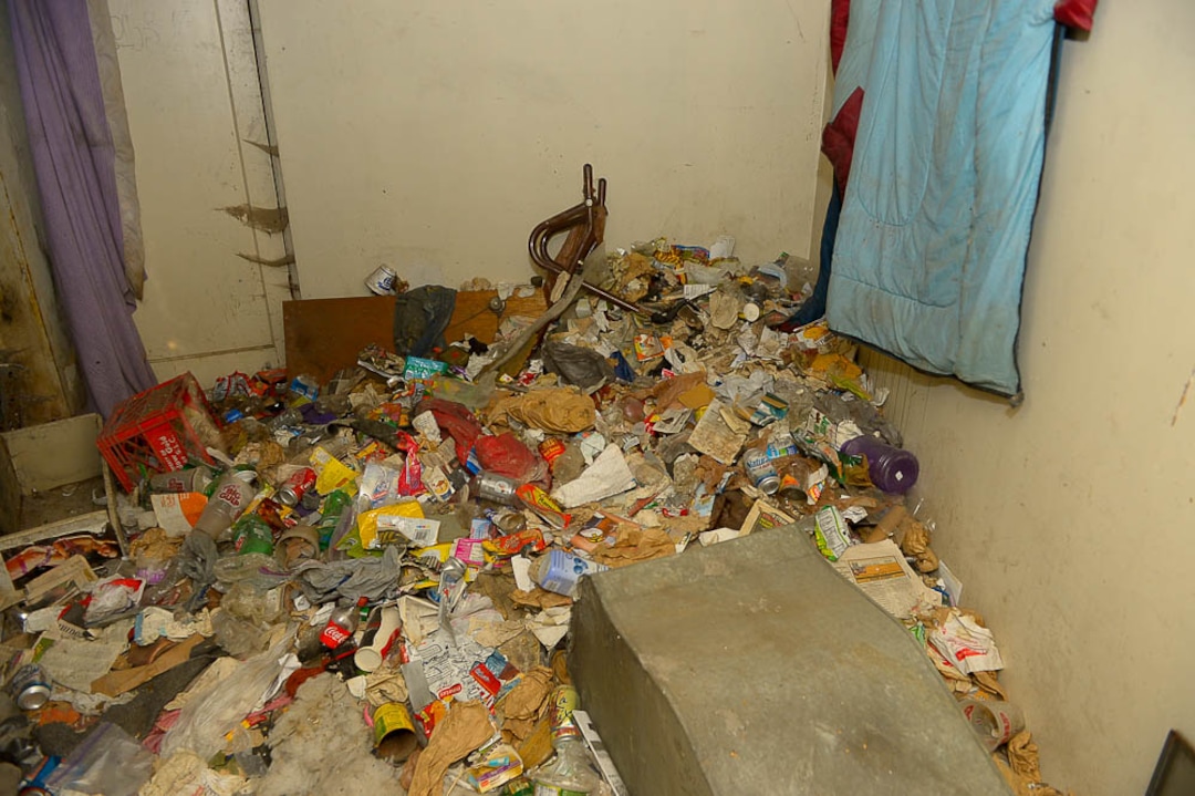 (Trent Nelson | The Salt Lake Tribune)  Garbage from squatters fills the basement of a dilapidated, fire-damaged building near 100 South 700 East in Salt Lake City, Thursday Feb. 15, 2018. Other Side Academy has received approval to demolish it for their expansion.