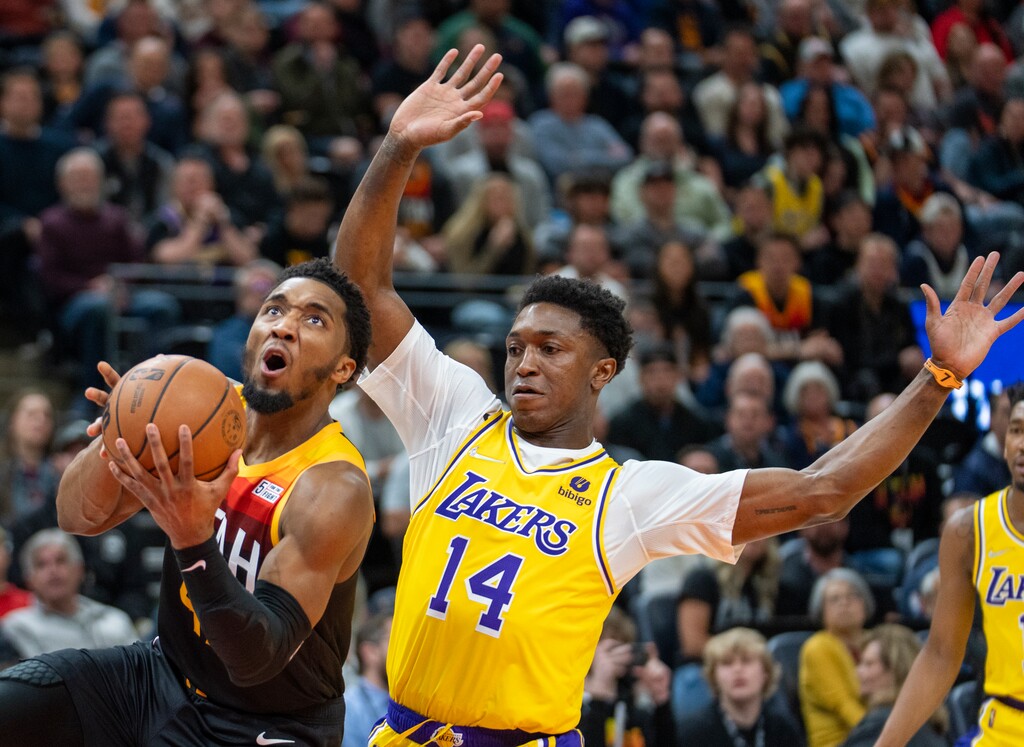 (Rick Egan | The Salt Lake Tribune) Utah Jazz guard Donovan Mitchell (45) takes the ball to the hoop, as Los Angeles Lakers forward Stanley Johnson (14) defends, in NBA action between the Utah Jazz and the Los Angeles Lakers, at Vivint Arena, on Thursday, March 31, 2022.
