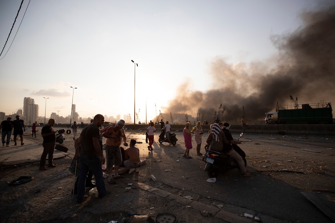 Smoke rises from a massive explosion in Beirut, Lebanon, Tuesday, Aug. 4, 2020. Massive explosions rocked downtown Beirut on Tuesday, flattening much of the port, damaging buildings and blowing out windows and doors as a giant mushroom cloud rose above the capital. Witnesses saw many people injured by flying glass and debris. (AP Photo/Hassan Ammar)