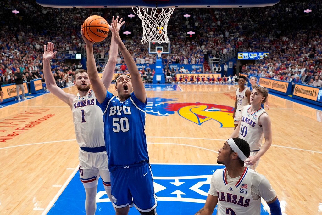 (Charlie Riedel | AP) BYU center Aly Khalifa (50) shoots during the second half of an NCAA college basketball game against Kansas Tuesday, Feb. 27, 2024, in Lawrence, Kan. BYU won 76-68.