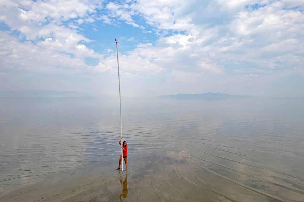 (Francisco Kjolseth  |  The Salt Lake Tribune)  A 25 foot pole gives a visual representation of the depth of the Great Salt Lake as open lands reporter Anastasia Hufham helps with reporting of depth from lakebed to surface of the shallow terminal lake on Tuesday, July 23, 2024. 