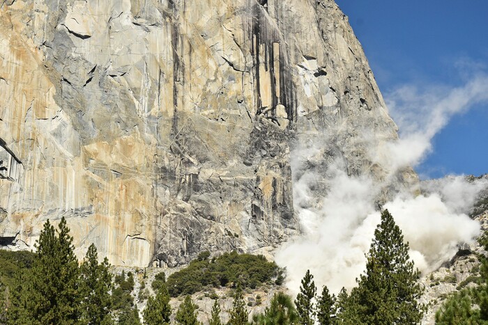 In this Wednesday Sept. 27, 2017, photo provided the National Park Service, a cloud of dust is seen on El Capitan after a major rock fall in Yosemite National Park, Calif. An official says the man killed when a massive hunk of rock fell of Yosemite National Park's El Capitan monolith was a British climber. Yosemite park ranger and spokesman Scott Gediman said Thursday that the man was with a British woman who was seriously injured. (Tom Evans/National Park Service via AP)