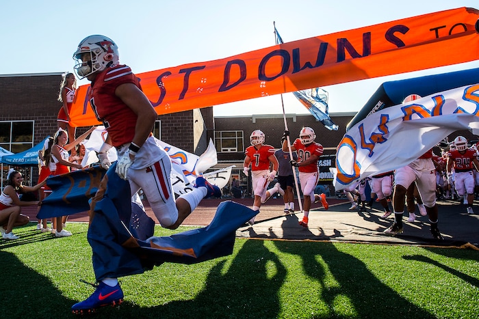 (Chris Detrick  |  The Salt Lake Tribune)  Members of the Timpview football team run onto the field before the game at Timpview High School Thursday, August 17, 2017. 