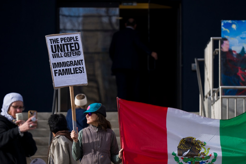 (Bethany Baker  |  The Salt Lake Tribune) Protesters gather outside of the U.S. Citizenship and Immigration Services building in Salt Lake City on Monday, Dec. 8, 2025.