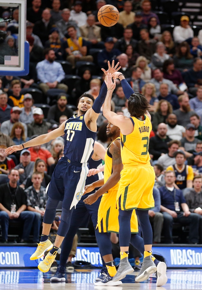 Utah Jazz guard Ricky Rubio (3) shoots as Denver Nuggets guard Jamal Murray (27) defends in the first half during an NBA basketball game Tuesday, Nov. 28, 2017, in Salt Lake City. (AP Photo/Rick Bowmer)