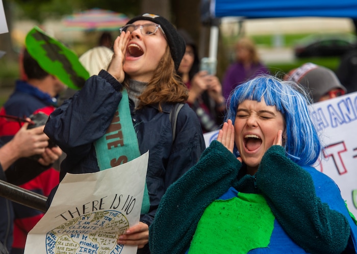 (Rick Egan  |  The Salt Lake Tribune)     Alee Lawlor, from Ames High School  wears a costume shaped like the earth as she chants along with the crowd outside Salt Lake City Hall at the Utah Youth Climate Strike.  Hundreds of young people from around the state gathered at the City Building, then marched to the Utah State Capitol, demanding action on the climate crisis. Friday, Sept. 20, 2019.