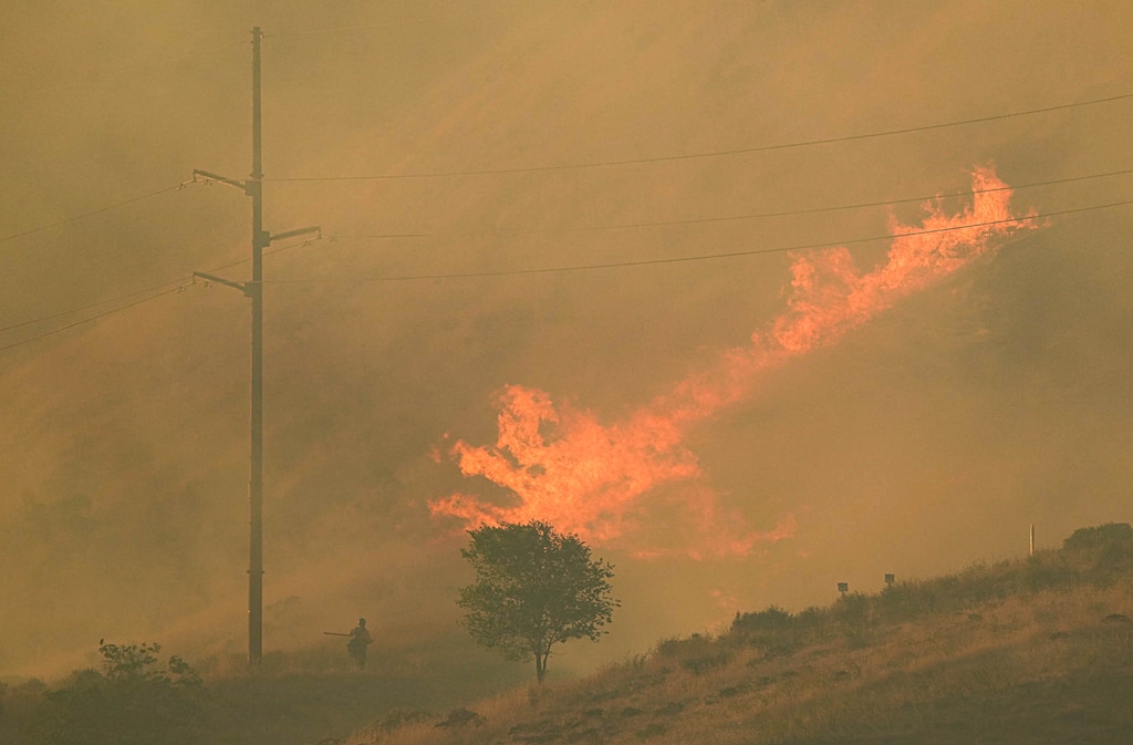 (Francisco Kjolseth | The Salt Lake Tribune) Crews battle the Bonneville Fire in the foothills above the University of Utah on Saturday, June 20, 2026. Low snowpack has left all of Utah more vulnerable to wildfires, officials say.