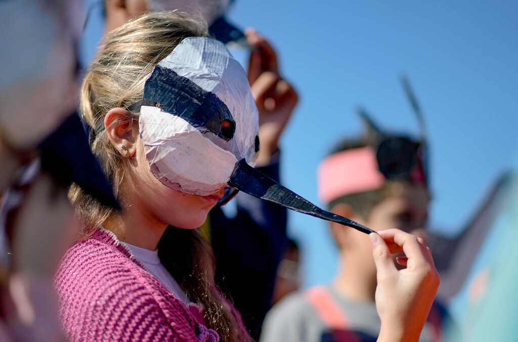 (Francisco Kjolseth | The Salt Lake Tribune) Clementine Nelson Kneciz wears a Wilson’s phalarope mask as she and other 6th grade classmates from Emerson Elementary join a rally at the Great Salt Lake on Wednesday, Oct. 1, 2025.