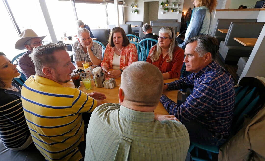 (Rick Bowmer | AP) Mitt Romney speaks with a group at Tamarisk Restaurant during a breakfast campaign stop, in Green River, March 3, 2018.