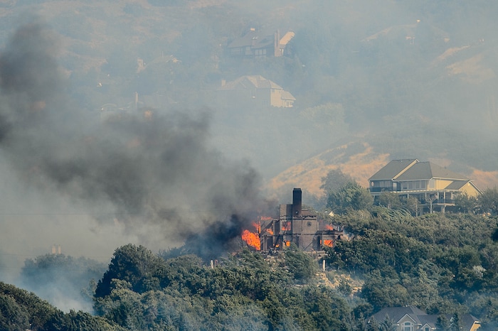 (Trent Nelson | The Salt Lake Tribune)  A home burns in at the mouth of Weber Canyon, Tuesday September 5, 2017.