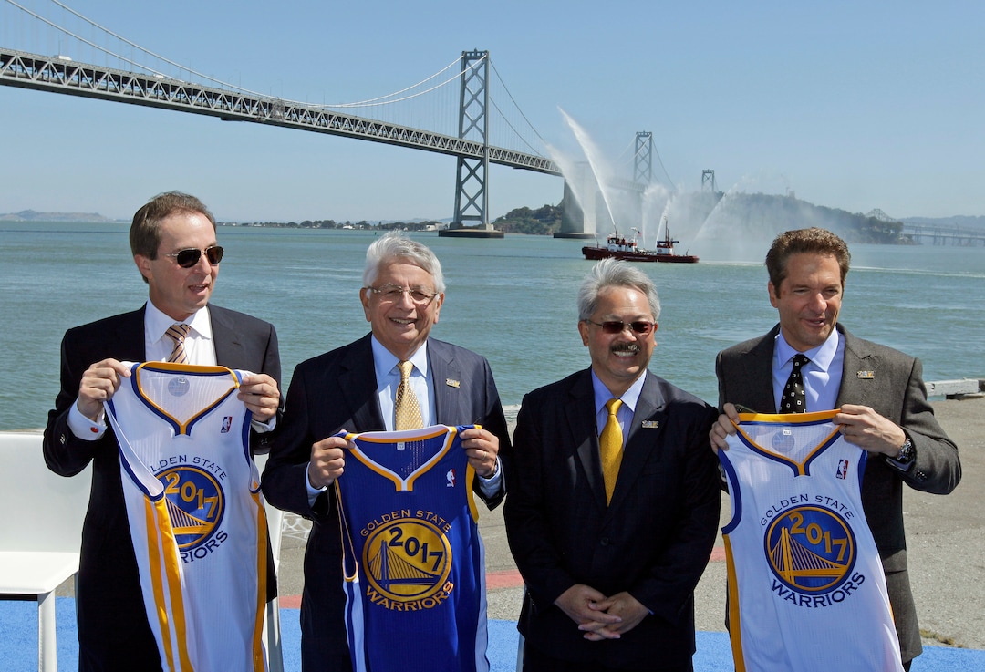 FILE - In this May 22, 2012 file photo, from left, Golden State Warriors owner and CEO Joe Lacob, NBA Commissioner David Stern, San Francisco Mayor Ed Lee and Warriors owner Peter Guber hold up 2017 jerseys following an announcement in San Francisco, that the NBA basketball team wants to build a new arena on the waterfront in San Francisco. Hundreds of people are expected for a public celebration in San Francisco Sunday, Dec. 17, 2017, of the life of Mayor Lee, who died suddenly Tuesday, Dec. 12, 2017. Lee, 65, was San Francisco's first Asian-American mayor and a former civil rights lawyer who led the city out of recession and into a dazzling economic recovery that has not benefited everyone. (AP Photo/Eric Risberg, File)