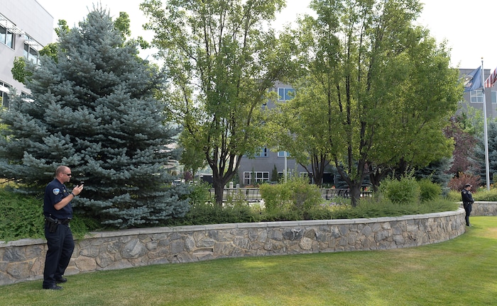 (Francisco Kjolseth  |  The Salt Lake Tribune)  Police close off access to where activists stage a protest against a private prison company with contracts to hold undocumented immigrants on Thursday, July 12, 2018, at the headquarters of Management and Training Corporation in Centerville.