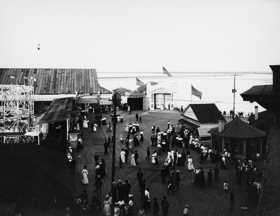 (Utah State Historical Society) Crowds mill about the amusement pier at Saltair, July 1907. Although the main attraction was swimming in the purportedly medicinal waters of the Great Salt Lake, there was also a roller coaster, a merry-go-round, a ferris wheel, midway games, bicycle races, touring vaudeville companies, rodeos, bullfights, boat rides on the lake, firework displays and hot-air balloons to name a few.
