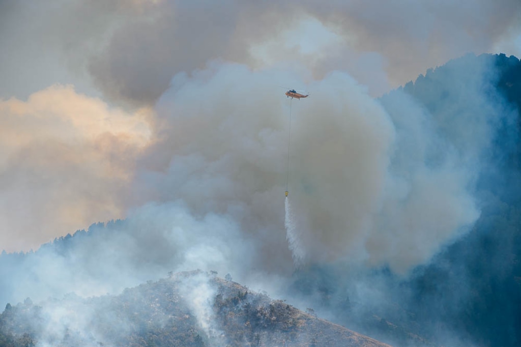 (Trent Nelson | The Salt Lake Tribune)
A helicopter makes drops on a wildfire east of Tooele. Friday July 27, 2018. Utah's largest electric utility, Rocky Mountain Power, had to pull back its wildfire management plan after foresters from the state pointed out weaknesses.
