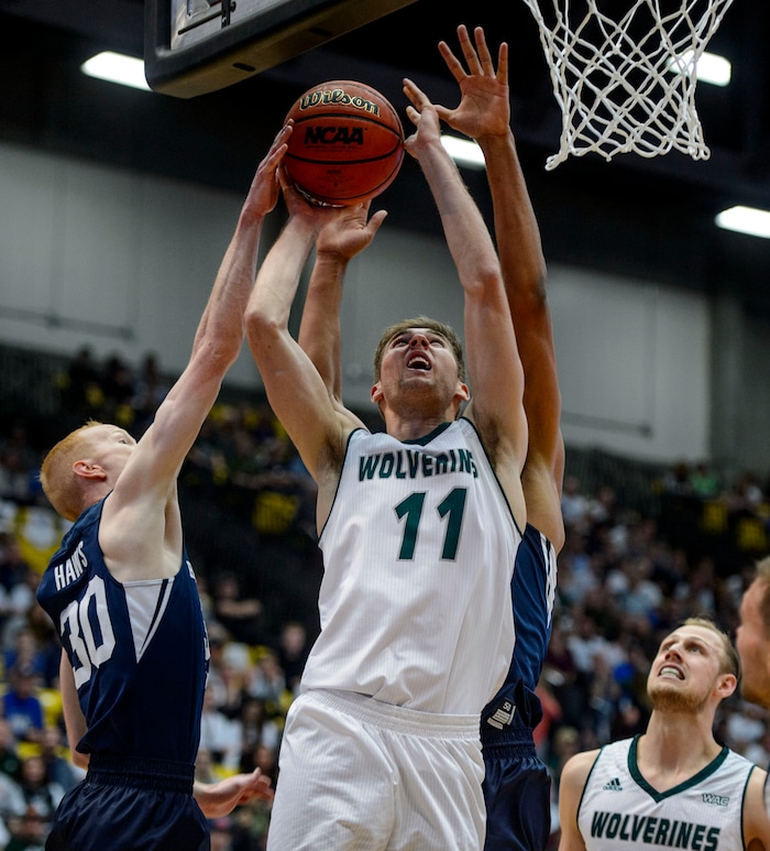 (Steve Griffin  |  The Salt Lake Tribune) Utah Valley Wolverines guard Conner Toolson (11) gets his shot blocked by Brigham Young Cougars guard TJ Haws (30) during the BYU versus UVU basketball game at UCCU Center on the UVU campus in Orem Wednesday November 29, 2017.