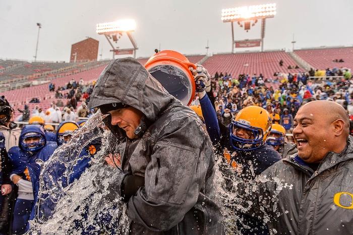 (Trent Nelson | The Salt Lake Tribune)  Orem players dump a cooler on their coach, Jeremy Hill, as Orem defeats Mountain Crest in the Class 4A High School State Football Championship game in Salt Lake City, Friday November 17, 2017.