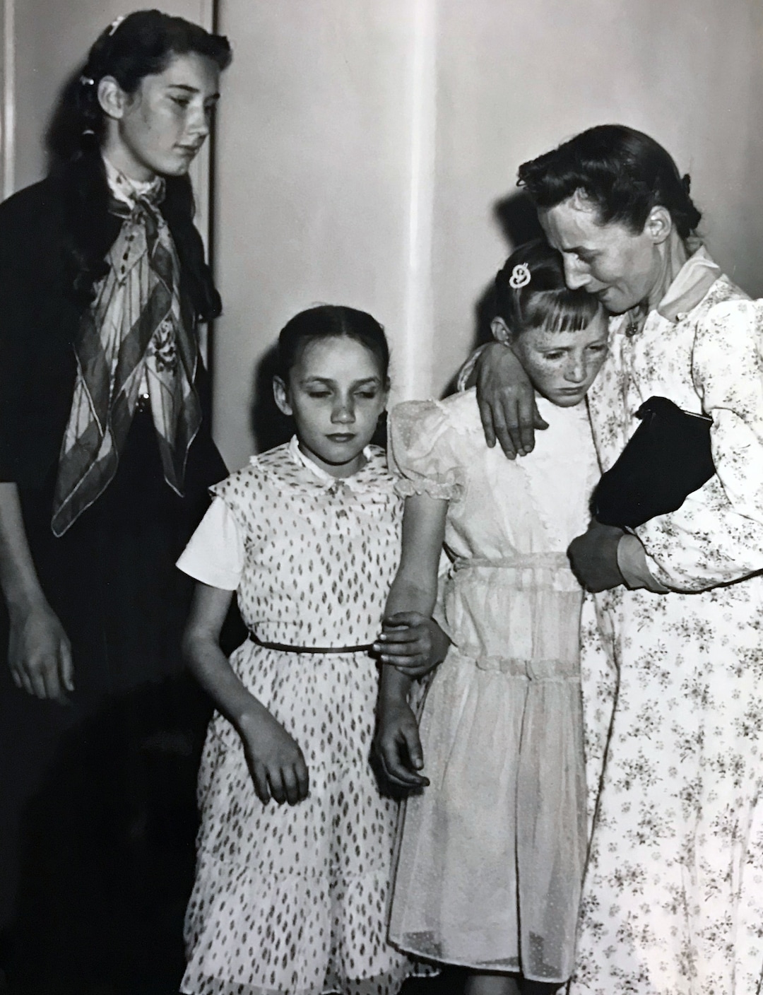 (Tribune file photo)  Vera Johnson Black comforts Elsie, 11, as Emily, 9, holds her sister's arm. At left is Lillian, 14. Black's children were placed in state custody after the 1953 raid on Short Creek, which lead to a Utah Supreme Court case.