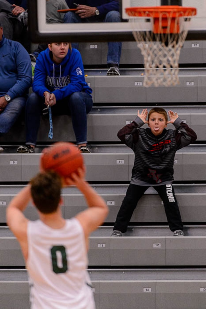 (Trent Nelson | The Salt Lake Tribune) A young American Fork fan works on distracting Olympus's Jeremy DowDell at the free throw line as American Fork hosts Olympus in the Utah Elite Eight tournament, Saturday December 9, 2017.
