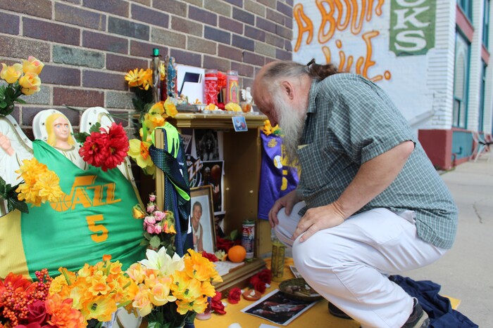 (Christopher Kamrani | The Salt Lake Tribune) Ken Sanders of Ken Sanders Rare Books reads a poem inside a Utah Jazz playoff shrine on the corner of 200 East and 300 South in downtown Salt Lake City on Monday, April 23, 2018.