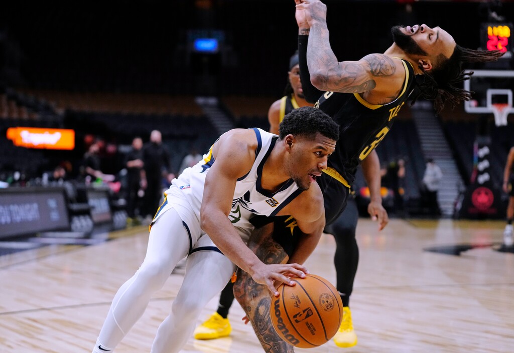 Utah Jazz guard Jared Butler (13) bumps against Toronto Raptors guard Gary Trent Jr. (33) during the second half of an NBA basketball game Friday, Jan. 7, 2022, in Toronto. (Frank Gunn/The Canadian Press via AP)