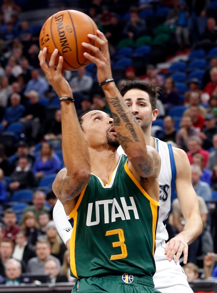 Utah Jazz's George Hill, left, in view of Minnesota Timberwolves' Ricky Rubio, of Spain, eyes a shot  during the first quarter of an NBA basketball game Saturday, Jan. 7, 2017, in Minneapolis. (AP Photo/Jim Mone)