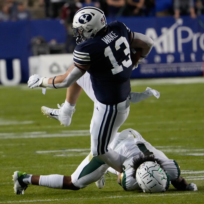 (Francisco Kjolseth | The Salt Lake Tribune) Brigham Young Cougars fullback Masen Wake (13) is taken down by South Florida Bulls safety Matthew Hill (1) in game action between the Brigham Young Cougars and the South Florida Bulls at LaVell Edwards Stadium in Provo, Saturday, Sept. 25, 2021.