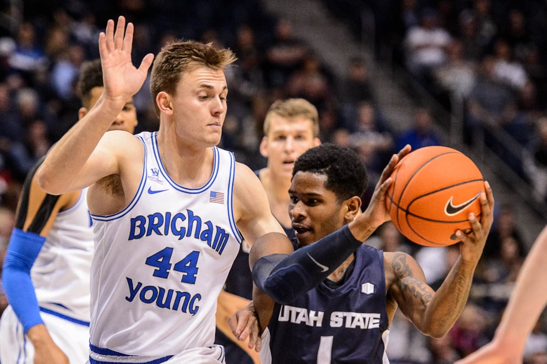 (Trent Nelson | The Salt Lake Tribune)  Utah State Aggies guard Tauriawn Knight (1) drives on Brigham Young Cougars guard Connor Harding (44) as BYU hosts Utah State, NCAA basketball in Provo on Wednesday Dec. 5, 2018.