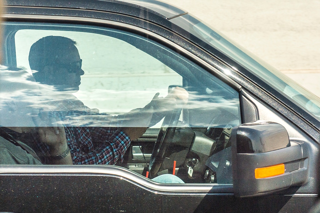 (Chris Detrick  |  Tribune file photo)
A driver uses his cellphone while driving on Interstate 15, July 13, 2017.