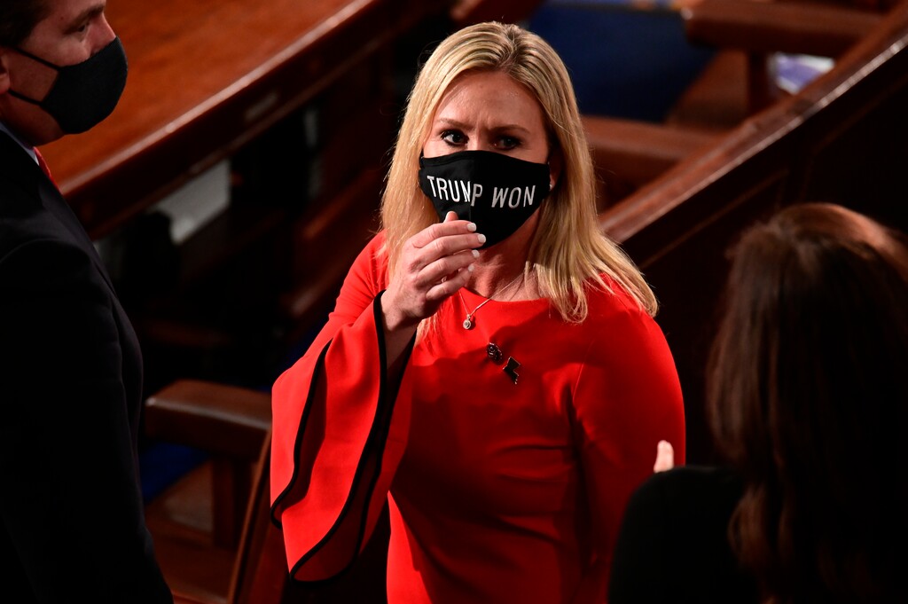(Erin Scott | File pool photo via AP) Rep. Marjorie Taylor Greene, R-Ga., wears a "Trump Won" face mask as she arrives on the floor of the House to take her oath of office on opening day of the 117th Congress on Jan. 3..