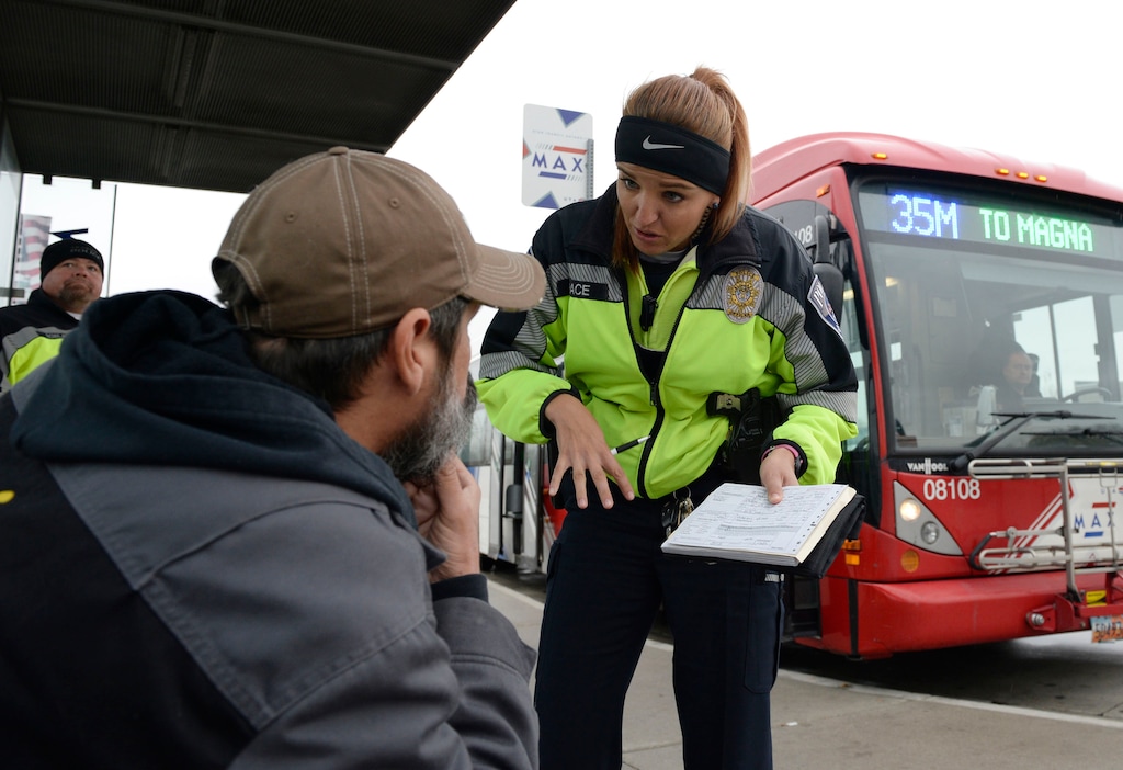 (Al Hartmann | Tribune file photo) In this 2017 file photo, UTA police officer Aymee Race explains the ticket she has just written up to a rider getting off a MAX bus who failed to buy a ticket.