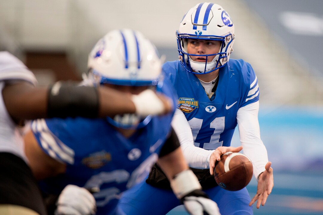 (Jeremy Harmon  |  The Salt Lake Tribune) Brigham Young Cougars quarterback Zach Wilson (11) takes the ball on a snap as BYU faces the Western Michigan Broncos in the Famous Idaho Potato Bowl in Boise, Idaho, on Friday, Dec. 21, 2018.